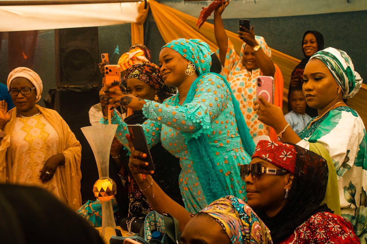 why-choose-us Women in colorful attire capturing moments at a lively celebration.